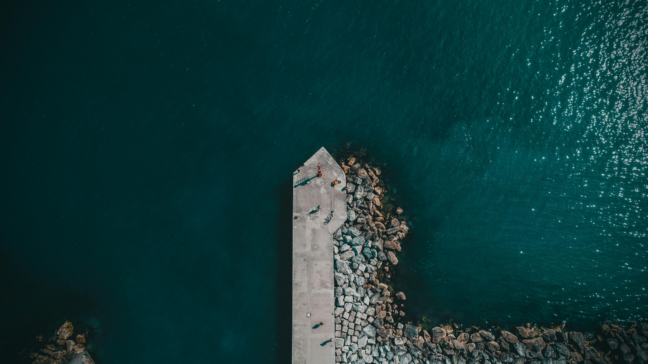Drone shot capturing the serene pier at Bellaria, Italy surrounded by turquoise waters.